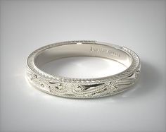 a wedding band with intricate engraving on it