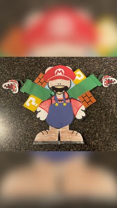 paper cut out of mario bros character on the ground