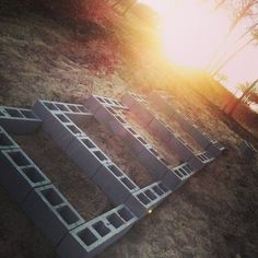 the sun is shining on some kind of structure made out of cinder blocks in the sand