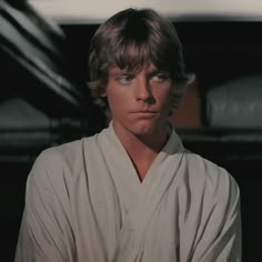 luke star wars the force awakes in his white robe and stares into the distance