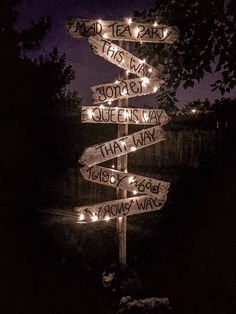 a wooden sign with lights on it that says road to the new queen's day