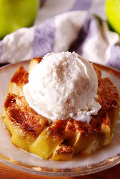 a plate topped with waffles and ice cream on top of a wooden table