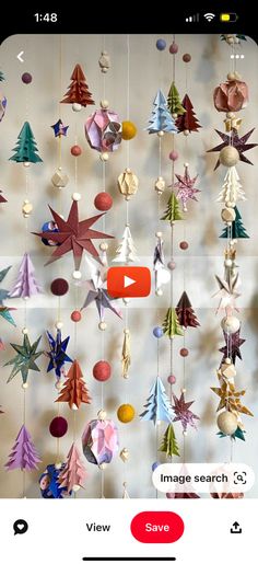 the video is showing how to make origami mobiles with paper stars and christmas trees