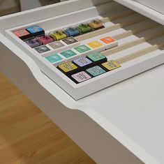 a white desk with several different colored objects on it