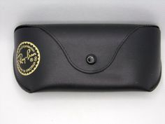 Item: Ray-Ban Glasses Case. Description: BLACK HARD SNAP CASE for eyeglasses. Size: Exterior of case measures approximately 6 ¼" x 1 ½" x 3" inches (interior will be slightly smaller). Condition: New without tags. Cases were purchased from an optometrist's office that had closed. As these were on display, case may have dust from storage, light handling marks and/or minor scratches/dents. Please see photos for sample of item. (photos may not be of the exact item shipped). Warranty: All items are Black Rectangular Case For Gifts, Classic Black Portable Cases, Black Rectangular Case As Gift, Classic Black Storage Cases, Ray Ban Glasses, Eyeglass Case, Glasses Case, Display Case, On Display