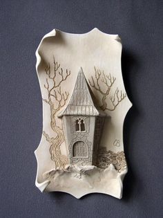 a decorative ceramic plate with a house on it