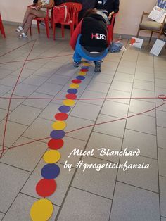 two children are playing on the floor with colored circles