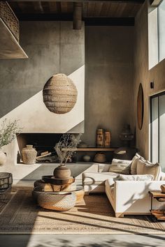 a living room filled with furniture and a fire place in the middle of an open floor plan