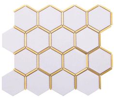 the white and gold hexagonal tiles are arranged together