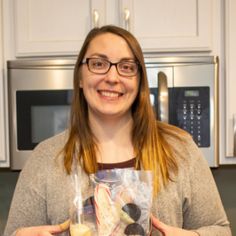 a woman holding a bag of food in her hands