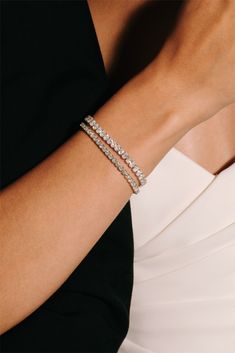 a woman's arm with three rows of bracelets on top of her wrist