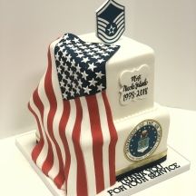 a cake decorated with an american flag and the u s air force emblem on top