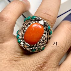 Ring Details - Natural Red Coral -  Main Stone Size: 17.00x13.00mm Approximate  - Ring Front width: 29.5mm - Small Turquoise in Setting: 4.30mm - Band Width: 8.40mm - Band Thickness: 3.00mm - Gross Weight: 40.00grams - Handmade Ring - Hand Engraved Design - Sterling Silver 925  - Hallmarked - Dimensions and Weight Depends on Variations in Sizes. - Available in all Sizes ( Please make sure about your ring sizes) - DM for Customizations NOTE: - Our Products are Made to Order According to Customer' Sterling Silver Gemstone Ring In Orange, Sterling Silver Orange Gemstone Rings, Orange Gemstone Ring In Sterling Silver, Sterling Silver Rings With Orange Gemstone, Artisan Red Oval Jewelry, Artisan Red Jewelry For Anniversary, Untreated Red Sterling Silver Jewelry, Artisan Red Ring Jewelry, Red Open Ring Stamped 925