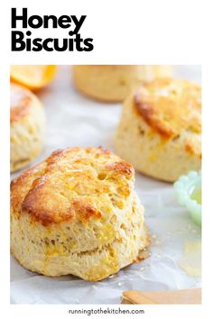 some biscuits are sitting on top of wax paper with the words honey biscuits