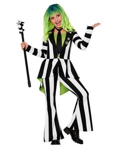 a woman with green hair and black and white striped suit is holding a stick in her hand