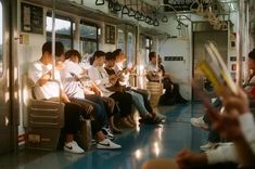 many people are sitting on the subway train