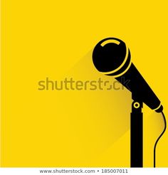 a microphone with long shadow on a yellow background