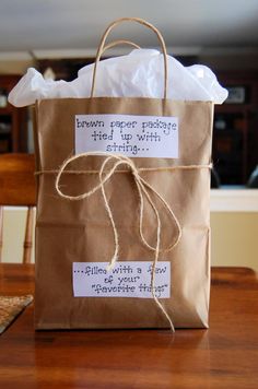 a brown bag with some writing on it and a tag that says, bag of his favorite things i diy valentine's for boyfriend