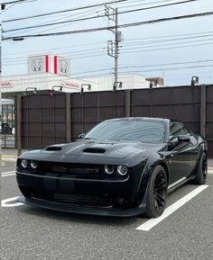 a black sports car parked in a parking lot