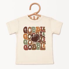 Looking for a cute tee for your kids? We have the perfect Gobble Turkey graphic tee addition to their closet! Also available in toddler tees. Playful Cartoon Print T-shirt For Fall, Playful Fall T-shirt With Cartoon Print, Unisex Letter Print T-shirt For Fall, Playful Crew Neck T-shirt For Fall, Unisex Fall Short Sleeve T-shirt, Unisex Short Sleeve T-shirt For Fall, Unisex Graphic Print T-shirt For Fall, Fall Short Sleeve T-shirt, Playful Pre-shrunk T-shirt For Fall