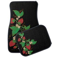 two car mats with strawberries and berries on them