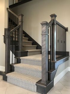 the stairs are made of wood and have black railings