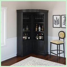 a black cabinet with wine glasses and liquor bottles on it in the corner of a room