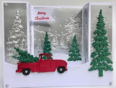 a christmas card with a red truck and trees