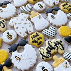 some decorated cookies are laying on a table with honey combs and bees in the background