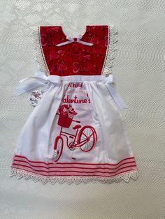 a red and white dress with a bicycle on it