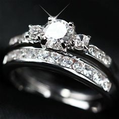 a couple of rings that are on top of each other with diamonds in the middle