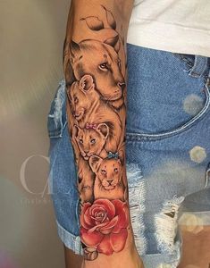 a woman's arm with an animal and rose tattoo on it