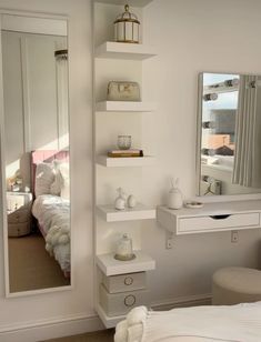 a bedroom with a bed, mirror and dressing table