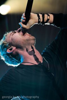 a man holding a microphone up to his head