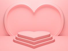 two heart shaped boxes sitting on top of each other in front of a pink background