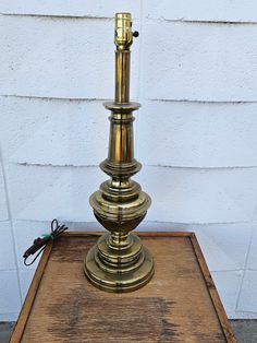 an antique brass lamp on a wooden table