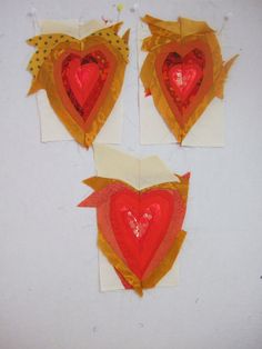 three pieces of paper with hearts cut out of them