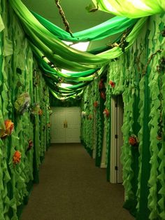 the hallway is decorated with green and orange ribbons, streamers, and paper flowers