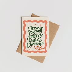 a card with the words have yourself merry little christmas written in green and orange on it