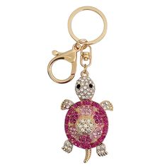 a keychain with a pink turtle on it's face and some diamonds