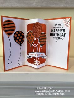 an open card with some balloons on it