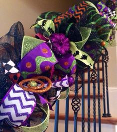 purple, green and black mesh wreath on the banister