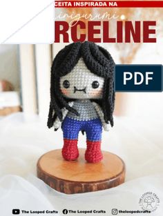 a crocheted doll is sitting on top of a piece of wood with the words reg