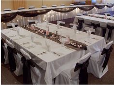 the tables are set with white and black linens