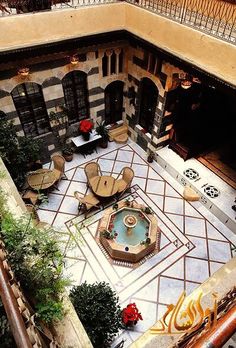 an aerial view of a courtyard with tables and chairs