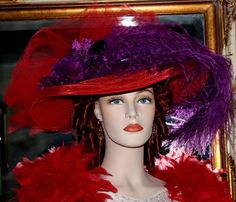 "This Victorian Hat is a stunning accessory that will draw in heads wherever you go. This East Angel Harbor Hat will be the perfect accent piece for any special occasion such as a tea party or birthday celebration. The beautiful red designer faux horsehair base has a full 18 inch diameter brim. Two luxurious purple silk roses adorn the front and a purple rosette behind the roses adds an extra glisten. The hat band is a stunning almost iridescent purple embroidered organza which is accented with Edwardian Tea Party, Tea Hat, Edwardian Hat, Crystal Fairy, Tea Hats, Victorian Hats, Purple Feather, Tea Party Hats, Tulle Bows