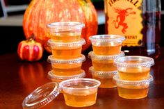 plastic cups filled with liquid sitting on top of a table