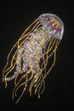 a jellyfish made out of beads and lights in the dark