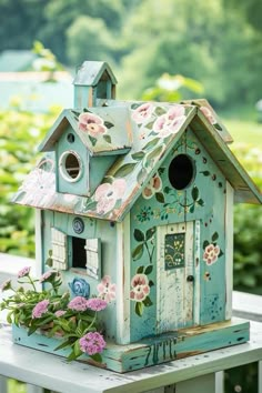 a bird house with flowers on the outside