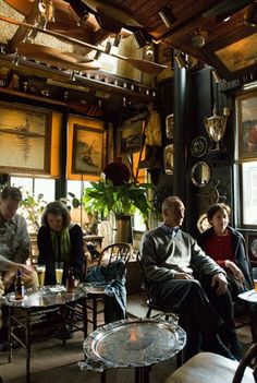 a group of people sitting around tables in a room